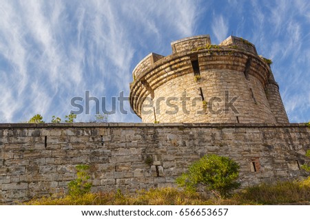 Ancient tower with stone wall