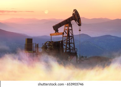 Ancient traditional classical oil pumps of Ukrainian oilmen in the Carpathians and Carpathian Mountains in the Polonies Delyatyn in the background of mountains in sunny weather
