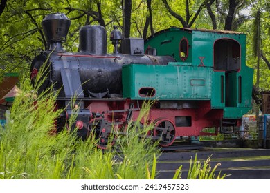 An ancient train powered by firewood is being used as a display at an amusement park  - Powered by Shutterstock