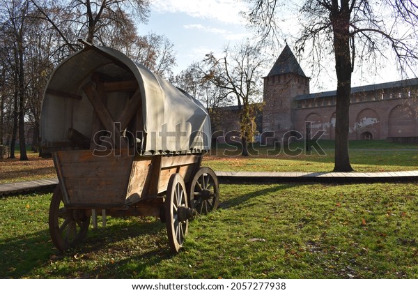 An\
ancient vehicle with background of a fortress\
wall