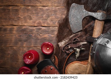 Ancient Viking Axe And Beast Fur Skin On The Old Wooden Table Flat Lay Table Background With Copy Space.