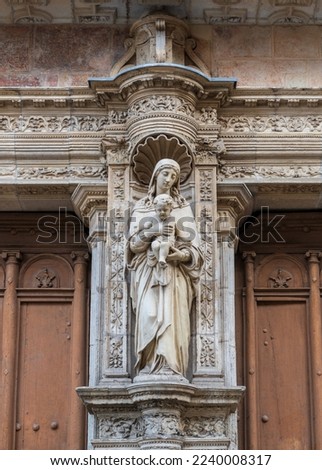 Ancient Virgin and Child stone statue at the entrance portal of Notre Dame de la Dalbade church, Toulouse, France