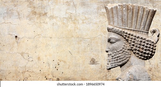 Ancient wall with bas-relief with assyrian warriors, Persepolis, Iran. UNESCO world heritage site. Horizontal background with embossed image persian bearded man. Mock up template. Copy space for text