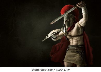 Ancient warrior or Gladiator posing over a dark background