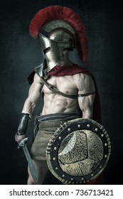 Ancient Warrior Or Gladiator Posing Over A Dark Background