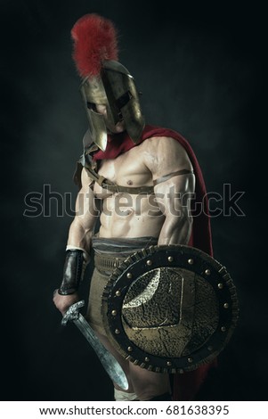 Ancient warrior or Gladiator posing over a dark background