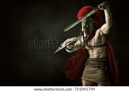 Ancient warrior or Gladiator posing over a dark background