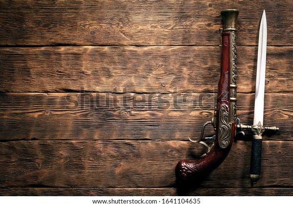 Ancient Weapon On Brown Wooden Table Stock Photo Edit Now 1641104635