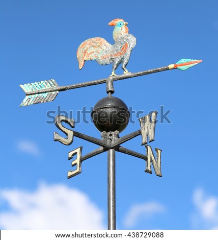 ancient weathervane with cock above an arrow and the four cardinal points North East West South
