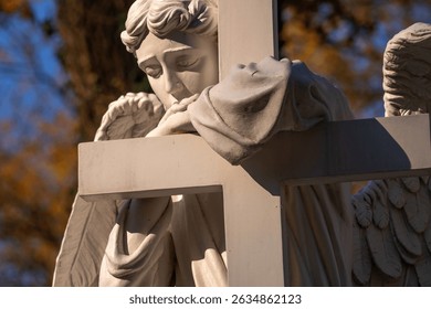 Ancient white statue of angel with cross as symbol of Christianity, death and resurrection of Jesus Christ. Close up horizontal image. - Powered by Shutterstock - Get 15% off with code: PIKWIZARD15