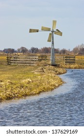 Ancient windmill in the Dutch fields and meadows
