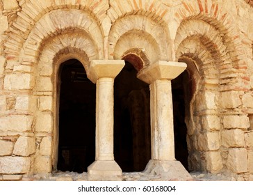 a ancient window with columns