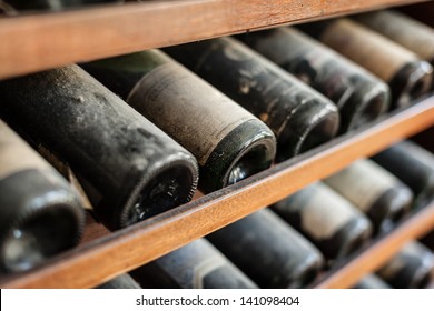 ancient wine bottles dusting in an underground cellar
