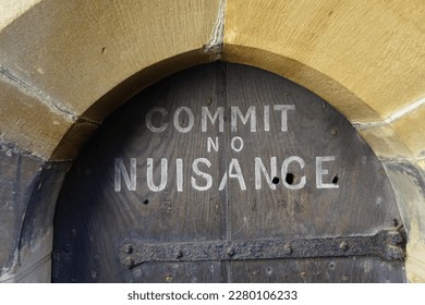 Ancient wooden door and commit no nuisance sign