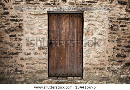 Ancient wooden door in stone castle wall. Tallinn, Estonia
