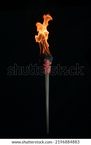 ancient wooden torch isolated on black background