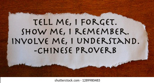 ancient words of wisdom on paper with torn edges and wood background