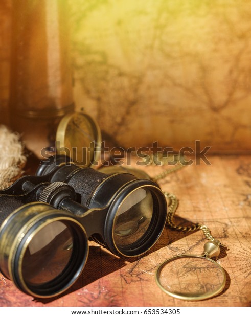 Ancient world map with a variety of accessories.\
Vintage still life. Travel\
concept.