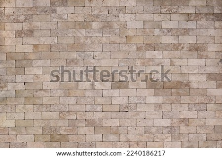 Ancient yellow brick wall background texture with old masonry close up