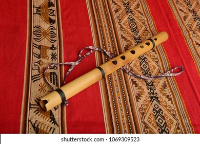Andean flute from South America on a colorful textile