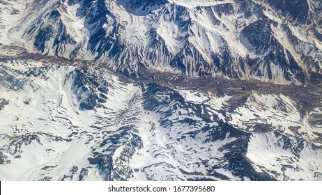 andes mountain range seen from airplane window