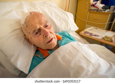 ANDOVER,HAMPSHIRE/UNITED KINGDOM- DECEMBER 25 2019:An Elderly Man With Brain Injury,a Relative Of The Photographer,lies In Bed At Kingfisher Rehab Ward,Andover War Memorial Hospital, Christmas Day.