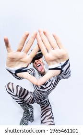 Androgenic Blonde Model In Freak Stylish Zebra Print Clothes And Leather Trendy Black Cap  Selfies In A White Studio. Clubbing Party Style