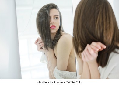 Androgynous Beautiful Young Man Like A Beautiful Woman With Red Lipstick Looks In A Mirror