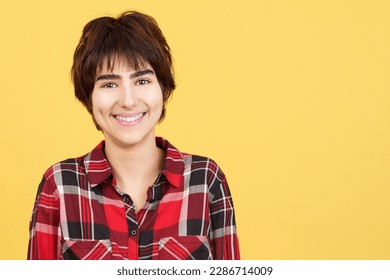 Androgynous person smiling while looking at camera - Powered by Shutterstock