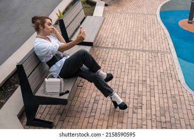 Androgynous Vain Man Taking Selfie Leaning On Black Gate In The Street