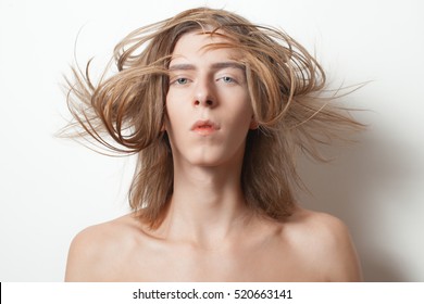 Androgynous Young Man With Hair On The Wind On White Background