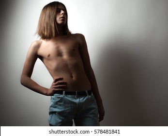 Androgyny Young Man Topless On White Background. Low Key