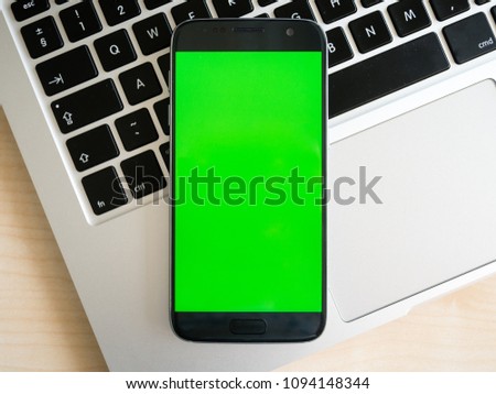 Android smartphone with green screen on notepad