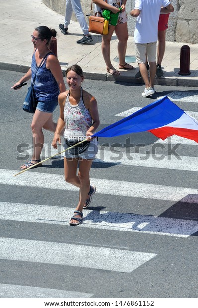 ANDUZE – FRANCE, JULY 23, 2019: Tour de\
France supporters and their French flag in\
Anduze