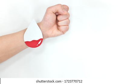 Anemia, Low Hemoglobin And World Blood Donor Day Concept. Arms With Blood Drop Paper Cutout.