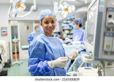 Anesthesiologist checking monitors while sedating patient before surgical procedure in hospital operating room. Young adult female African American patient is asleep on operating table during surgery. - Powered by Shutterstock