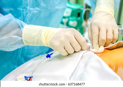 An anesthesiologist establishes a central catheter to the patient before surgery.