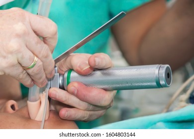 Anesthesiologist Performing An Endotracheal Intubation To A Female Patient At The Beginning Of A Surgery