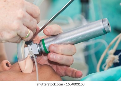 Anesthesiologist Performing An Endotracheal Intubation To A Female Patient At The Beginning Of A Surgery