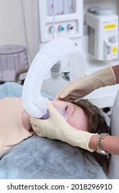 Anesthesiologist-resuscitator Introduces The Child Under General Anesthesia. A Child With An Oxygen Mask On His Face. Preparing A Child For Surgery.