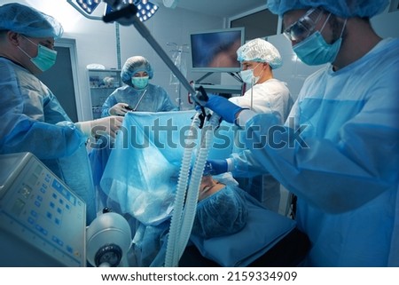 Anesthetist holding oxygen mask pressed to patient face during operation Сток-фото © 