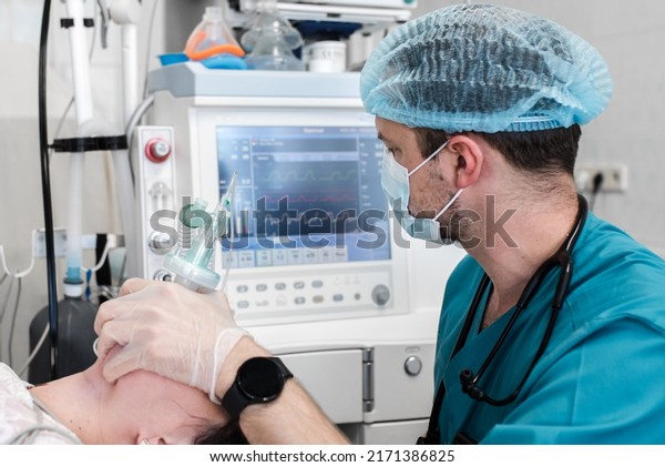 Anesthetist observes the\
monitor on the ventilator while the patient is being anesthetized.\
Anesthesiologist gives anesthesia to female patient before\
operation in a clinic.\
