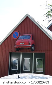 Anga,Gotland/Sweden-July 19 2020: Front Side Of An Garage With Half Of A Mini Car