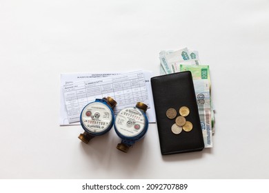 ANGARSK, IRKUTSK REGION, RUSSIA - December 18, 2021: Utility Bills Payment Concept. Receipts For Housing Payments, Water Meters And Russian Money In A Wallet On A White Background