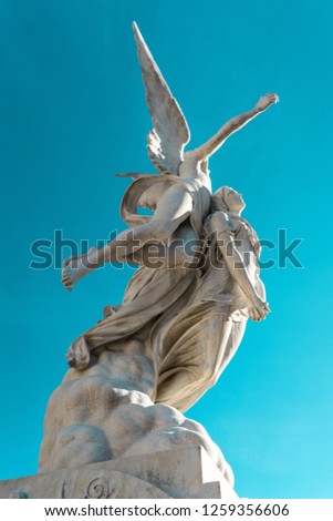 ANGEL ASCENDING WITH WOMAN FUNERARY MONUMENT IN POBLENOU CEMETERY, BARCELONA