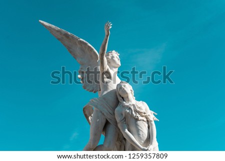 ANGEL ASCENDING WITH WOMAN, FUNERARY MONUMENT IN POBLENOU CEMETERY, BARCELONA