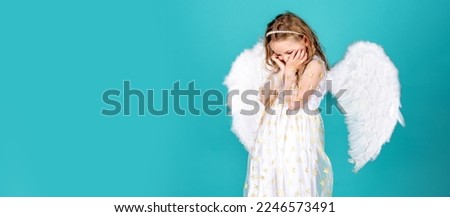 Angel child banner, isolated studio background. Face of beautiful little angel girl on color background. Pretty little angel girl. Child with angelic face.