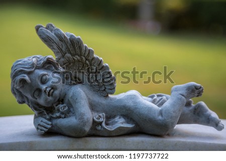 Angel with closed eyes lies on the belly