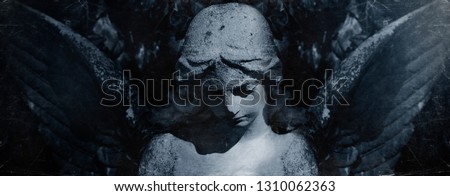 Angel of death. Retro styled ancient statue of sad angel as symbol of pain, fear and end of life.