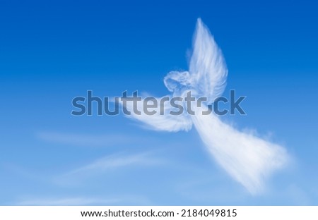 Angel flying in the sky. Angel-shaped cloud